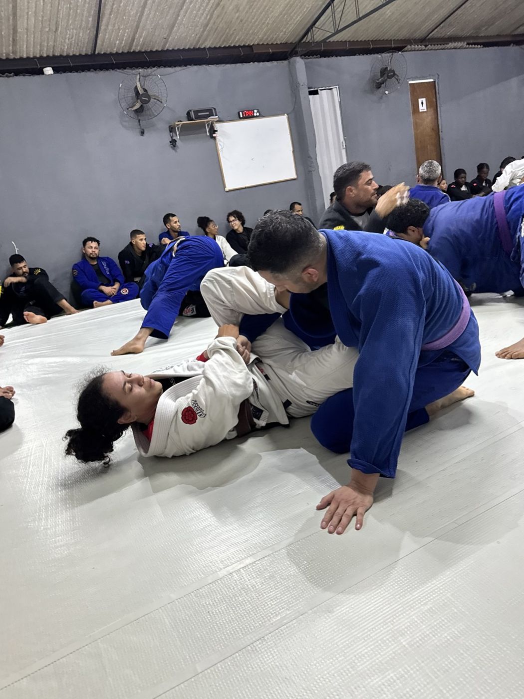 A student working from mount during open rolls in Brazil